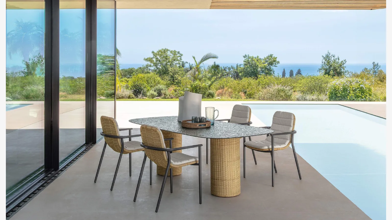 Glass table and Bond rattan chairs by Talenti.