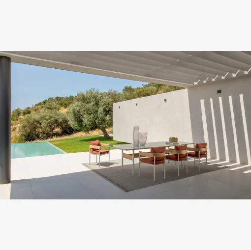 Table in stoneware and chairs in wood and Flow fabric by Talenti.