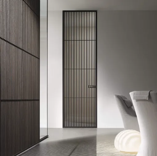 Sail interior door in thermotreated Oak wood and Rimadesio glass.